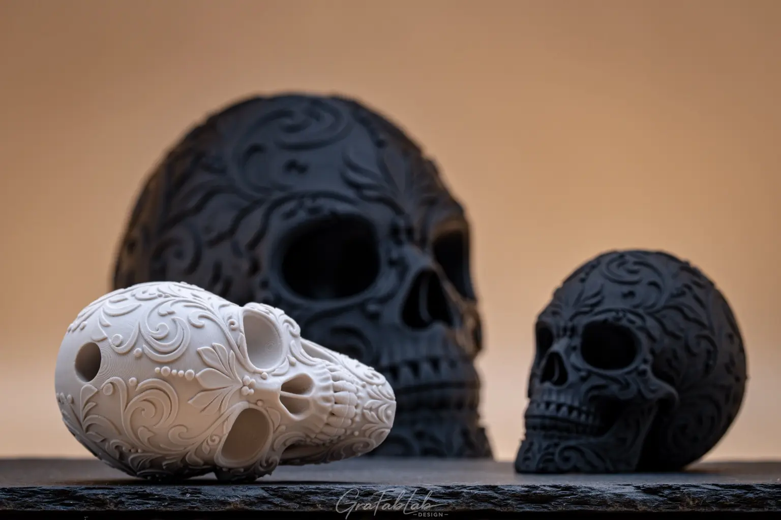 Black and white ornamental skull prototypes in several sizes